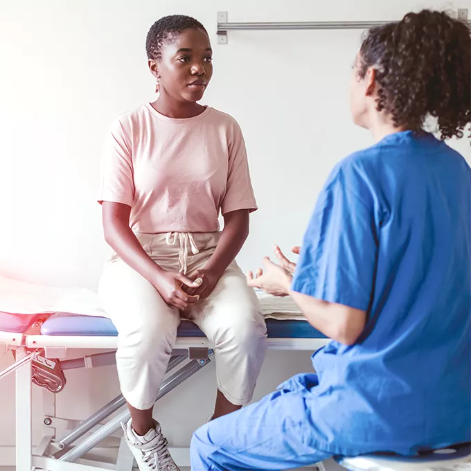 doctor talking to patient in examine room 